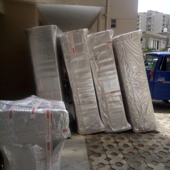 Mattresses and furniture wrapped in protective sheeting, Jaipur packers and movers