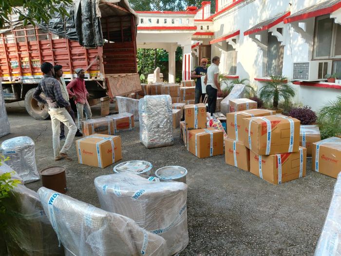 Packed cartons and furniture staged next to the moving truck, Jaipur