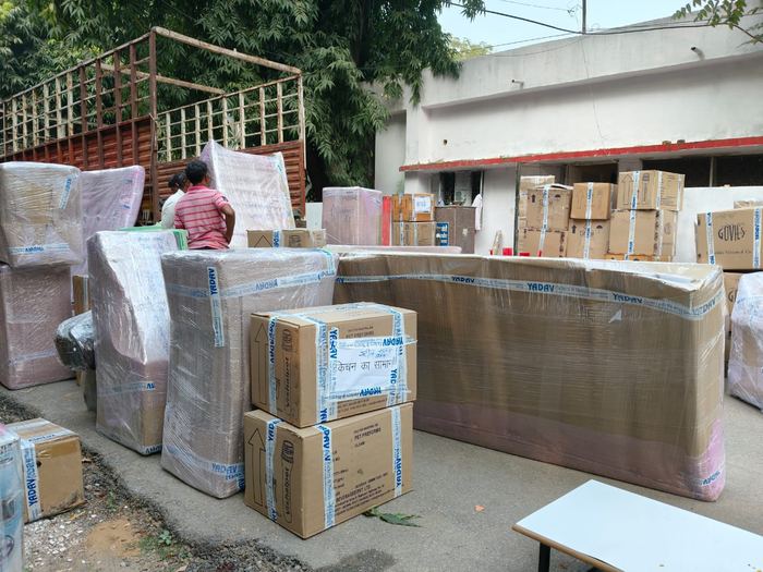 Vedanta Cargo and Movers crew wrapping sofa and packing boxes in Jaipur