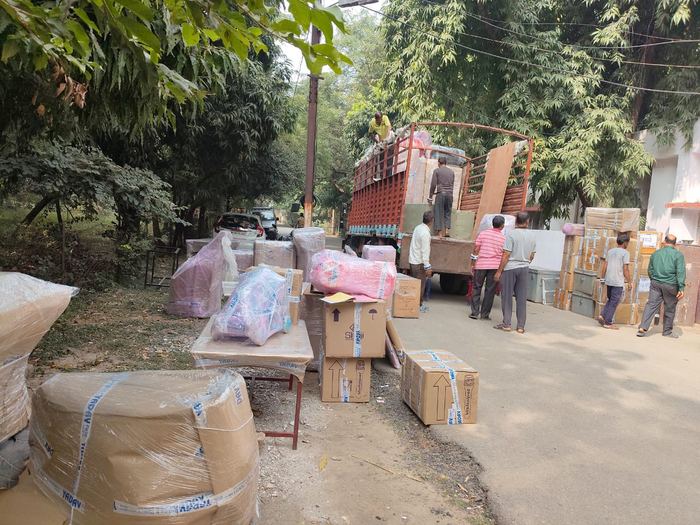 Packed boxes and furniture lined up roadside for loading, Jaipur movers